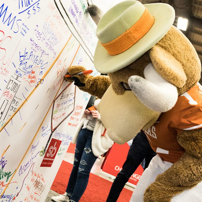 UT Mascot Signs the Coloring Wall at the SXSW EDU 2019 Playground. Photo by Bob Johnson.