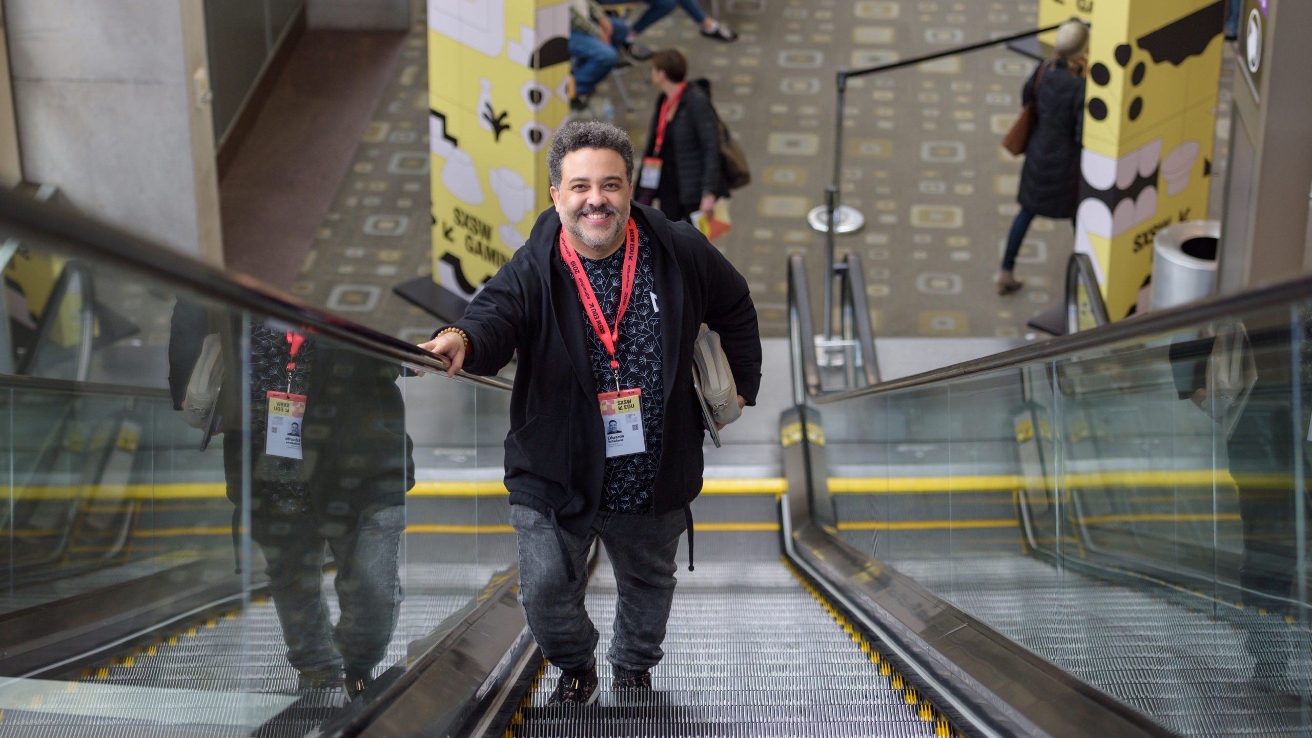 Man going up on escalator at SXSW EDU